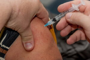 Representative Image: Person holding syringe while injected to skin. Photo Source: PickPik