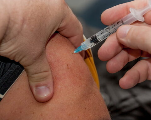 Representative Image: Person holding syringe while injected to skin. Photo Source: PickPik