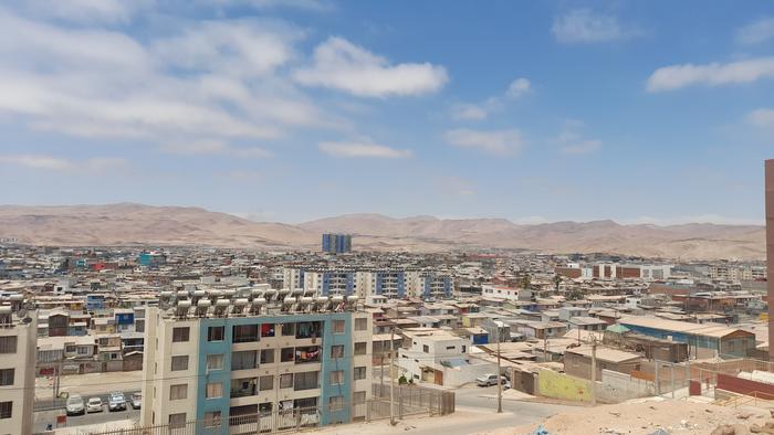 A panoramic view of an urban landscape set against a backdrop of arid, mountainous terrain. Photo Source - EurekAlert