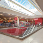 Representative image. Bright, spacious retail store with escalator and clothing section. Photo Source: Nicholas Eckhart (CC BY-NC-SA 2.0)