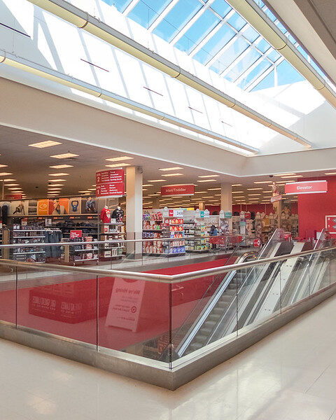 Representative image. Bright, spacious retail store with escalator and clothing section. Photo Source: Nicholas Eckhart (CC BY-NC-SA 2.0)