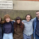 Group of five smiling people outside Manchester Crown Court. Photo Source: Just Stop Oil.