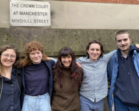 Group of five smiling people outside Manchester Crown Court. Photo Source: Just Stop Oil.