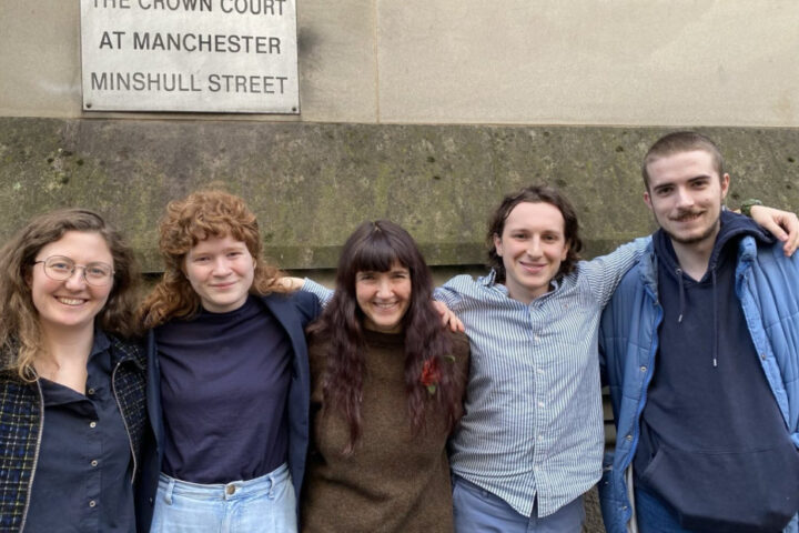 Group of five smiling people outside Manchester Crown Court. Photo Source: Just Stop Oil.