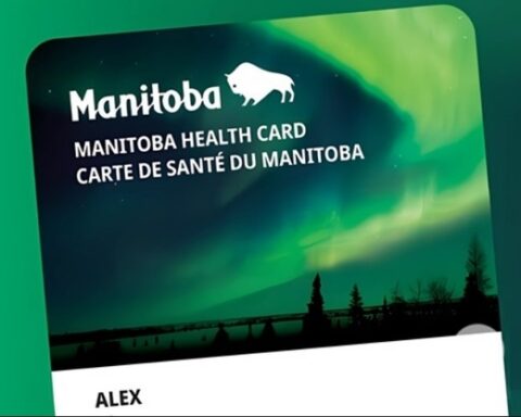 Manitoba Health Card with a dark silhouette of trees and a lake, giving it a visually appealing design. Photo Source: Government of Manitoba