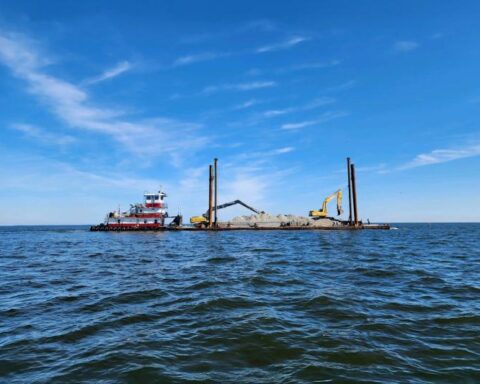 Open ocean with a barge carrying construction equipment. Photo Source: Stevens Towing