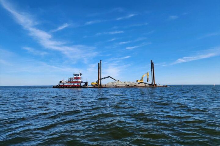 Open ocean with a barge carrying construction equipment. Photo Source: Stevens Towing