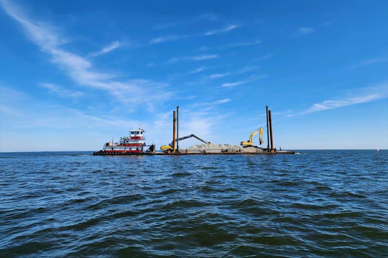 Open ocean with a barge carrying construction equipment. Photo Source: Stevens Towing