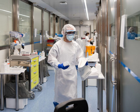 Representative Image. A medical or laboratory setting with individuals wearing full protective gear. Photo Source - Hospital Clinic (CC BY-ND 2.0)