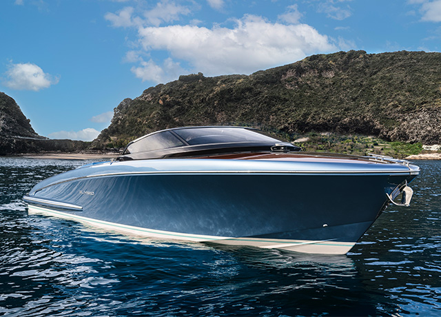 A sleek motorboat with a polished wooden deck. Photo Source - Riva