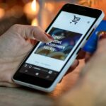 Representative image. Person Using Black And White Smartphone and Holding Blue Card. Photo Source: AS Photography