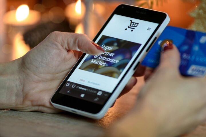 Representative image. Person Using Black And White Smartphone and Holding Blue Card. Photo Source: AS Photography