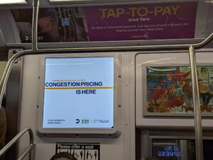 Representative Image: Congestion pricing announcement on the NYC subway. Photo Source: Sdkb (CC BY-SA 4.0)