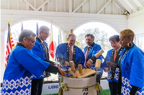 A ceremonial sake barrel breaking ceremony (kagami biraki) with government officials and Senior Managing Executive Officer Nishida