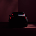 The car's rear, with sleek taillights, glowing in a dimly lit environment. Photo Source - Volvo Cars