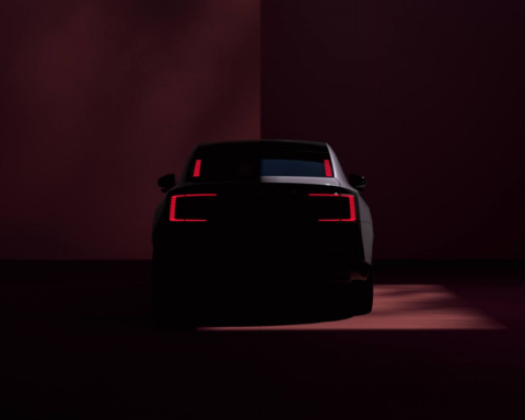 The car's rear, with sleek taillights, glowing in a dimly lit environment. Photo Source - Volvo Cars