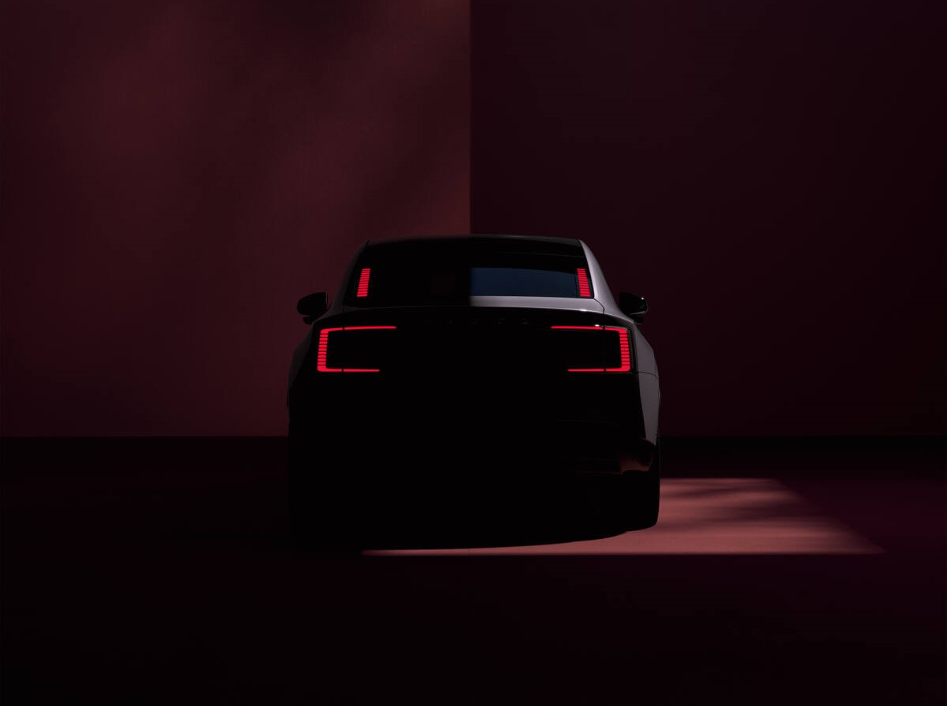 The car's rear, with sleek taillights, glowing in a dimly lit environment. Photo Source - Volvo Cars