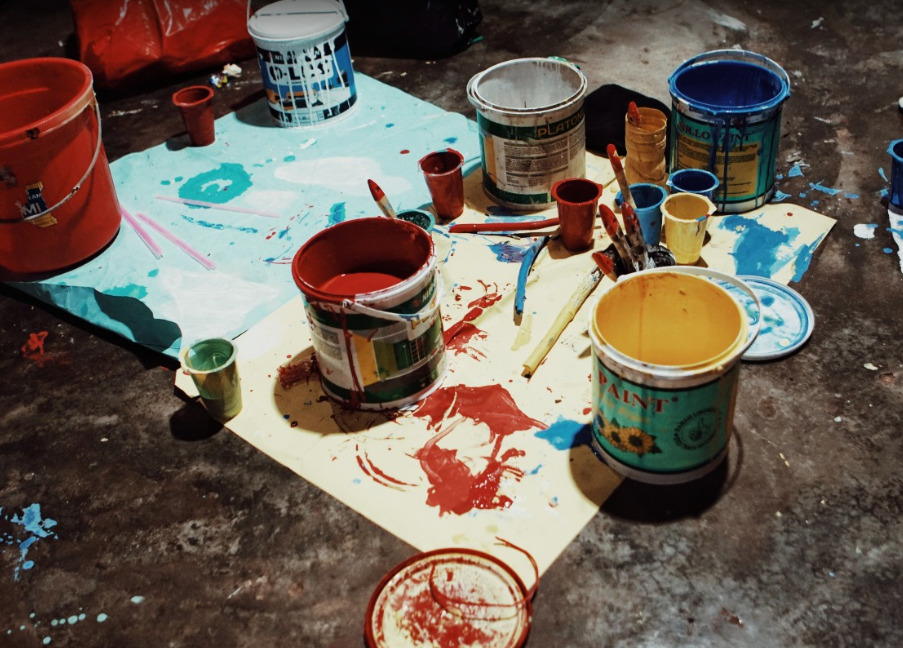 Representative Image. A cluttered workspace with an assortment of paint cans. Photo Source - Pxhere