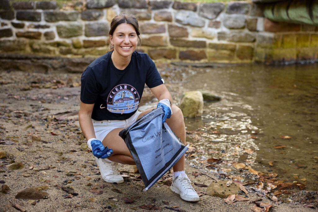 A person cleaning up  wet area. Photo Source - Clean Up Australia