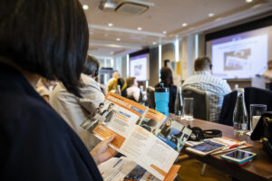 Representative Image. A person holding and reading a brochure. Photo Source - DG EMPL (CC BY-ND 2.0)