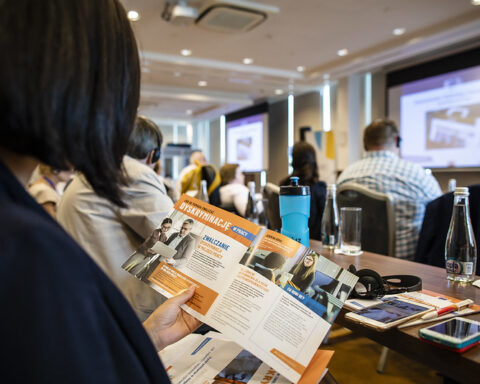 Representative Image. A person holding and reading a brochure. Photo Source - DG EMPL (CC BY-ND 2.0)