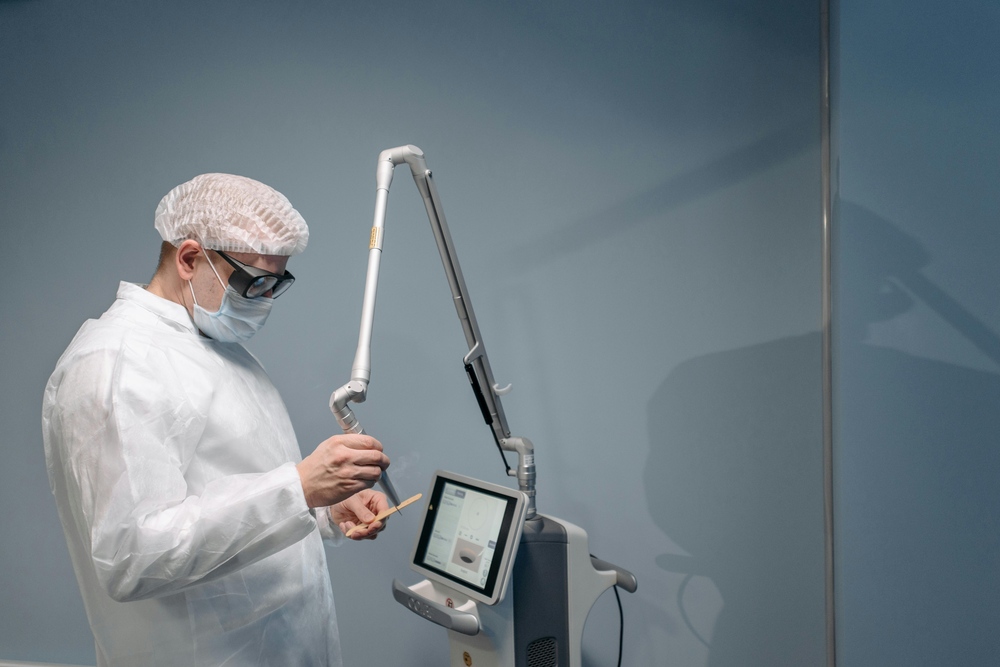 The man operating a medical or cosmetic laser device, performing a procedure requiring hygiene and safety precautions. Photo Source: Pexels (Pavel Danilyuk)