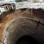 Representative Image: Massive sinkhole in an urban area, with buildings on the edge of the collapse. Photo Sourse: John C Bullas BSc MSc PhD MCIHT MIAT (CC BY-NC-ND 2.0)