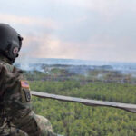 Representative image. Soldier observes wildfire from helicopter. Photo Source: SC National Guard (Twitter).