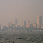 Representative Image. A bustling urban setting under a hazy atmosphere, due to pollution or fog. Photo Source - Christian Haugen (CC BY 2.0)