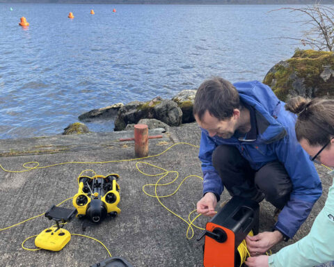 2 individuals engaged in a task involving a remotely operated underwater device. Photo Source - The Loch Ness Centre (Facebook)