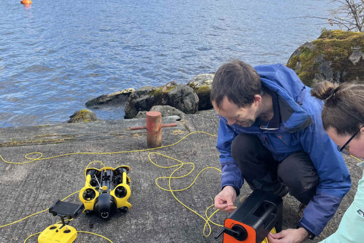 2 individuals engaged in a task involving a remotely operated underwater device. Photo Source - The Loch Ness Centre (Facebook)