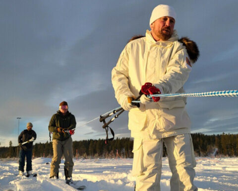 Teams pull rope in snow. Photo Source: Adam Zewe (MIT News).