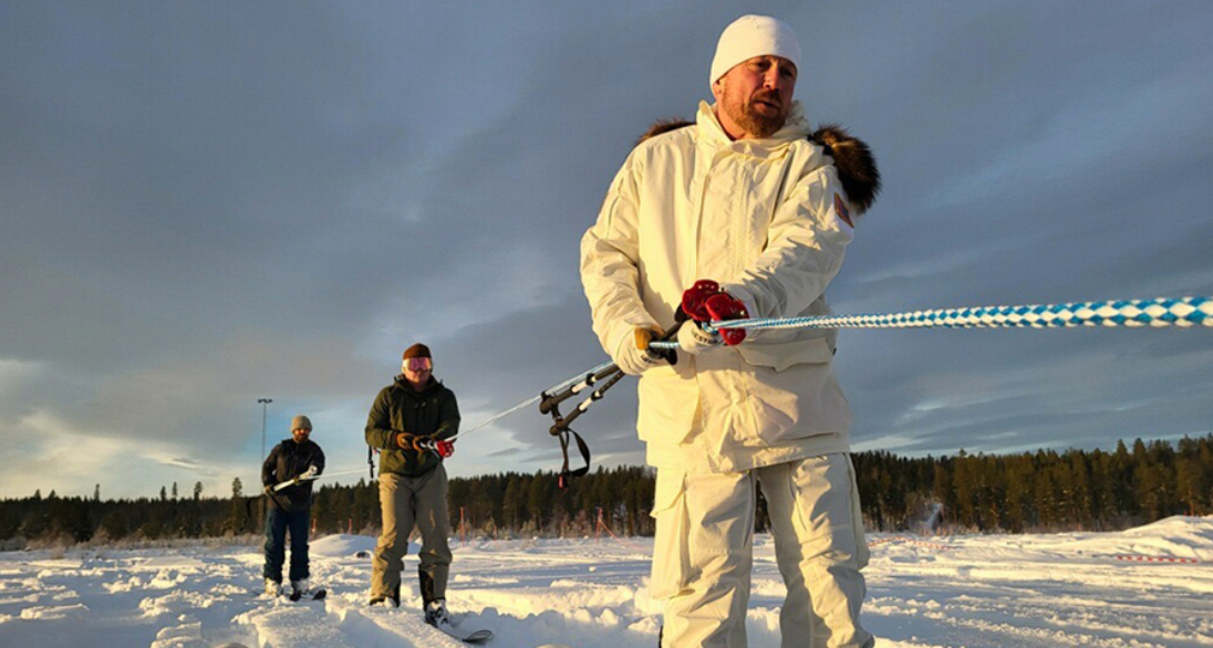 Teams pull rope in snow. Photo Source: Adam Zewe (MIT News).