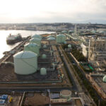 Representative Image: An industrial port facility with large storage tanks, pipelines, and processing units, related to liquefied natural gas (LNG) or petrochemical storage. Photo Source: Σ64 (CC BY 3.0)