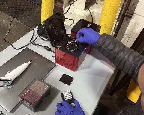 Florida International University scientist Diego Cardeñosa inserts the collected samples from imported fish into the PCR device to identify the fish species. Photo Source:: NOAA Fisheries