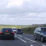 Representative Image. A two-lane road with several vehicles traveling in both directions. Photo Source - Gotham Nurse (CC BY-SA 2.0)