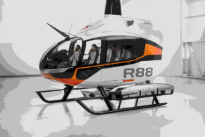 A helicopter, model R88, parked inside a hangar with a sleek and modern design. Photo Source - Robinson Helicopter Company