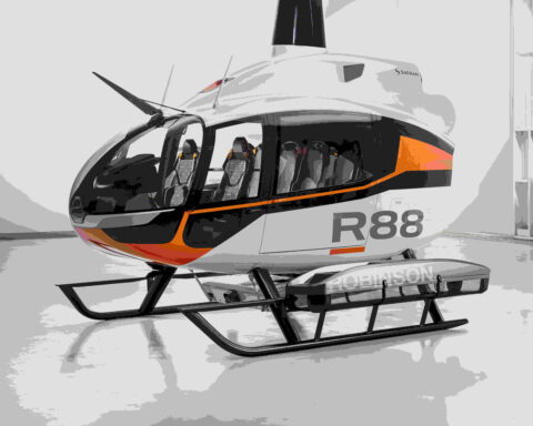 A helicopter, model R88, parked inside a hangar with a sleek and modern design. Photo Source - Robinson Helicopter Company