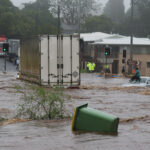 Representative Image: Trapped woman on a car roof during flash flooding in Toowoomba, Photo Source: Timothy Swinson (CC BY 2.0)