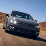 Gray hatchback driving on desert road. Photo Source: Golf GTI (vw.com).