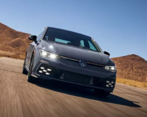 Gray hatchback driving on desert road. Photo Source: Golf GTI (vw.com).