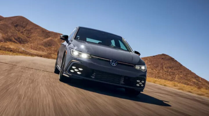 Gray hatchback driving on desert road. Photo Source: Golf GTI (vw.com).