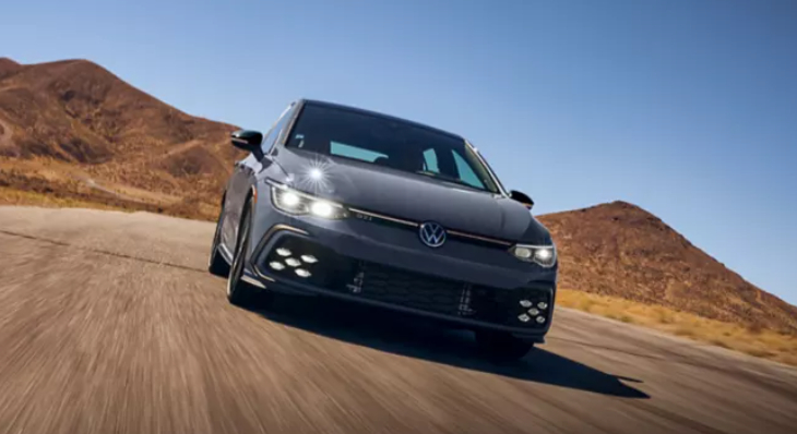 Gray hatchback driving on desert road. Photo Source: Golf GTI (vw.com).