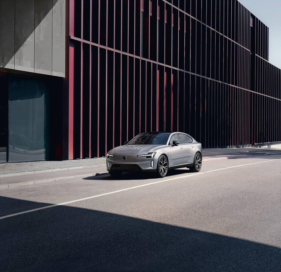 Featuring a sleek, modern car parked on an urban street with a stylish architectural background. Photo Source: Volvo Cars Global Newsroom