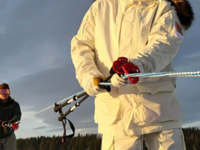 Teams pull rope in snow. Photo Source: Adam Zewe (MIT News).